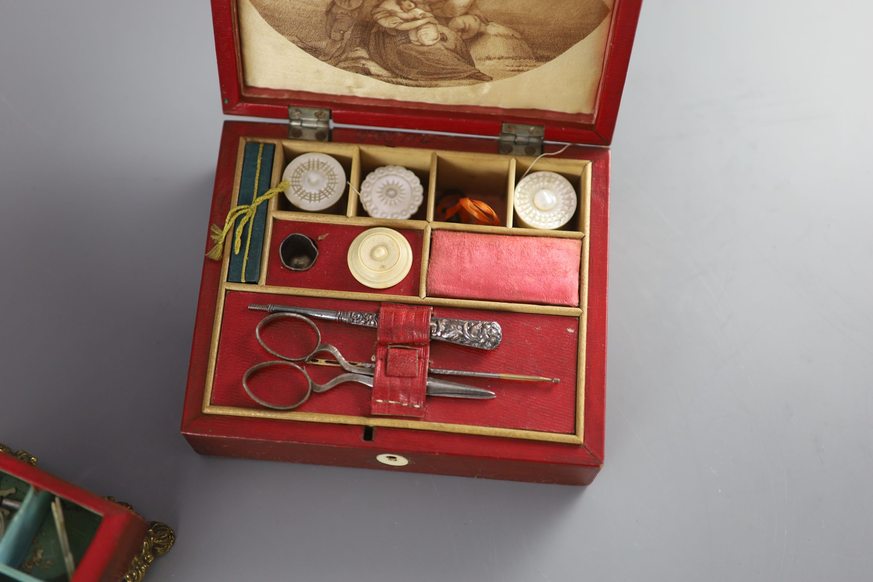 Two early 19th century red leather work boxes with assorted fittings